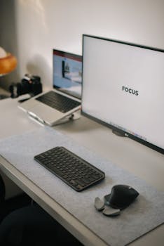 A tidy office desk with a laptop and monitor emphasizing organization and focus.