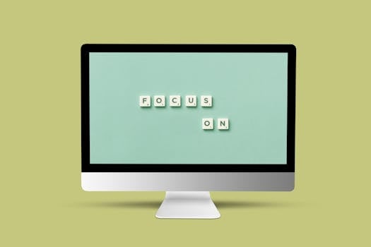 Computer monitor with 'Focus On' message using Scrabble tiles on screen for motivation and focus.